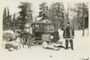 Image of Snowmobile ready for trip to Nain, Martin Vorse (Cook) standing by